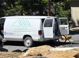 Wright's Roofing & Construction, Inc. van on-site for a roof replacement.